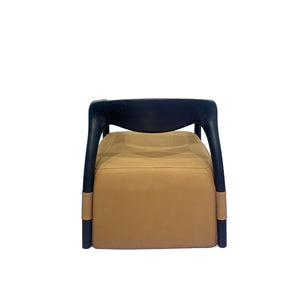 Beige Dune armchair by BEACON with plush fabric, wooden legs, and modern design, shown from a side angle.