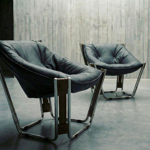 Black Cocoon Lounge Chair by BEACON, featuring a cozy, rounded design with smooth upholstery and sturdy metal legs.