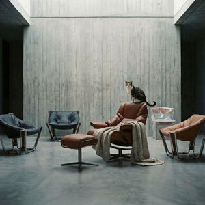 Brown Cocoon Lounge Chair by BEACON, modern rounded seat with plush upholstery and supportive armrests, stylish and comfortable.