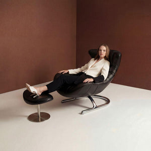 Vexel black lounge chair with matching ottoman from BEACON, modern design with cushioned seating and sleek frame.