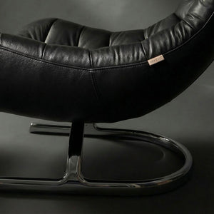 Vexel black lounge chair with matching ottoman by BEACON, modern design for comfortable seating and relaxation.