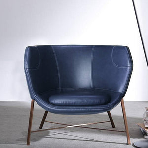 Blue Aprilia armchair from BEACON featuring plush fabric and modern design, perfect for living rooms or cozy spaces.