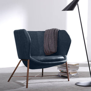 Aprilia armchair by Beacon with plush blue upholstery, modern design, and cushioned seat for comfortable seating.