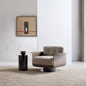 A beige BEACON Avenor armchair display model with plush fabric and wide armrests, shown from a side angle.