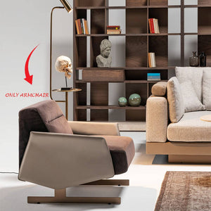 HOMAGE KOLTUK Edessa armchair with plush fabric upholstery and modern design, featuring curved armrests and wooden legs.