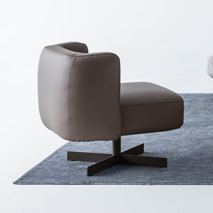 Foresta armchair by HOMAGE KOLTUK featuring a modern design with soft fabric upholstery and wooden legs.