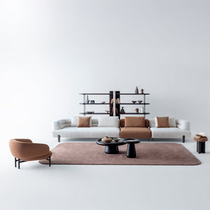 Homage Koltuk Freda armchair with plush fabric upholstery and modern design, shown in a cozy living room setting.