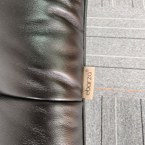 Vexel black lounge chair with matching ottoman by BEACON, modern design and comfortable seating for living room decor.