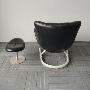 Black Vexel lounge chair with matching ottoman by BEACON, modern design, comfortable seating for living room relaxation.