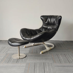 Vexel black lounge chair with matching ottoman by BEACON, modern design and comfortable seating for living room.
