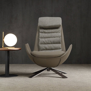 Dark beige Severo lounge chair by BEACON, featuring a modern design with plush cushions and sleek wooden legs.