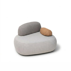 BEACON Cumulus lounge chair armchair with plush fabric, featuring wooden armrests and a modern design, shown in a cozy living room setting.