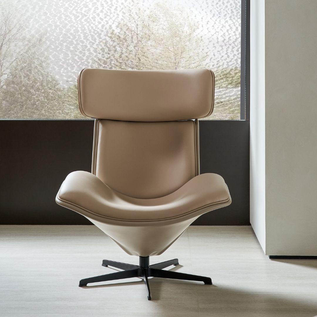 BEACON Bolo lounge armchair with plush upholstery and modern design, shown in a cozy living room setting.