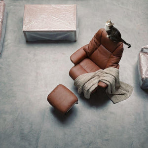 Beacon Meridian lounge chair with matching ottoman in caramel leather, modern design and plush cushioning for comfortable seating.