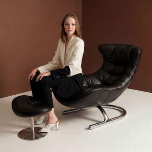 Vexel black lounge chair with matching ottoman by BEACON, modern design, upholstered seating and wooden legs.