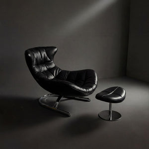 Vexel black lounge chair with matching ottoman by BEACON, modern design and comfortable seating in a stylish living space.
