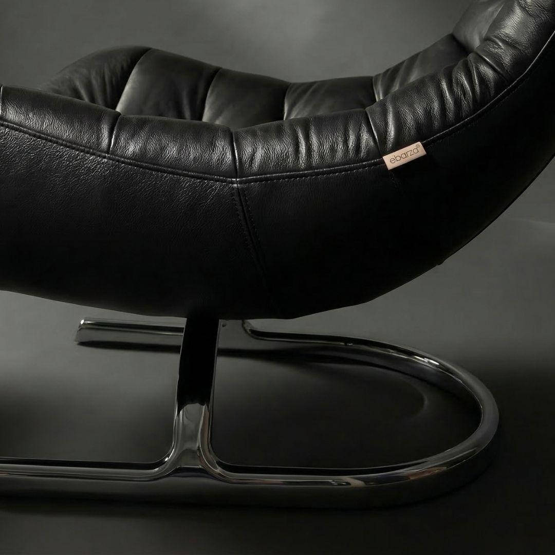 Vexel black lounge chair with matching ottoman by BEACON, modern design for comfortable seating and relaxation.