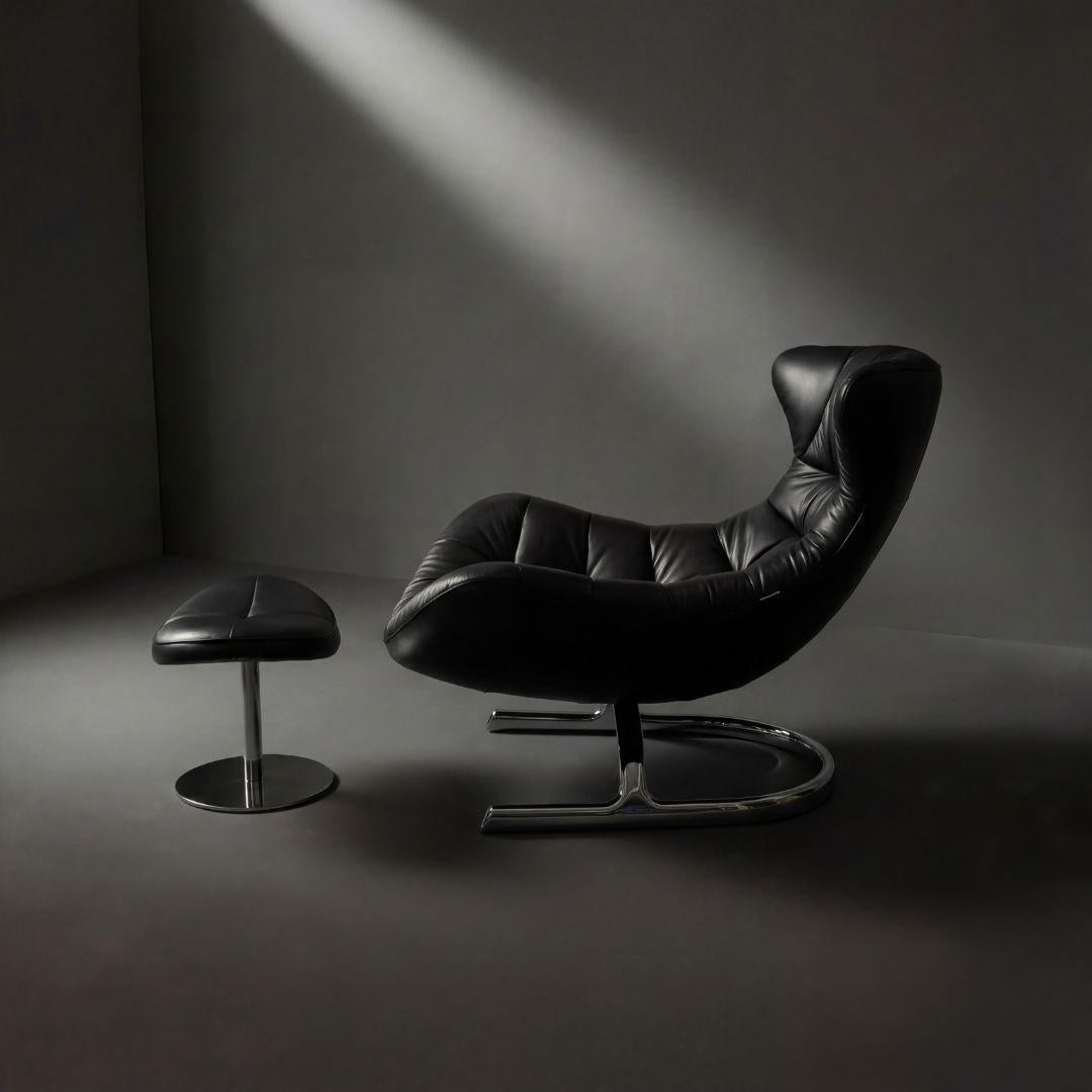 Vexel black lounge chair with matching ottoman by BEACON, modern design, plush cushioning, and sleek wooden legs.