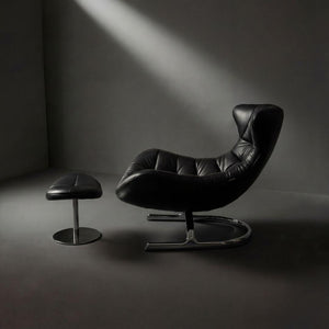 Vexel black lounge chair with matching ottoman by BEACON, modern design, plush cushioning, and sleek wooden legs.