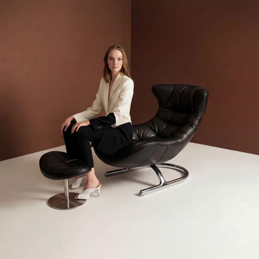 Black Vexel lounge chair with matching ottoman by BEACON, modern design, plush cushions, ideal for relaxing and stylish living spaces.