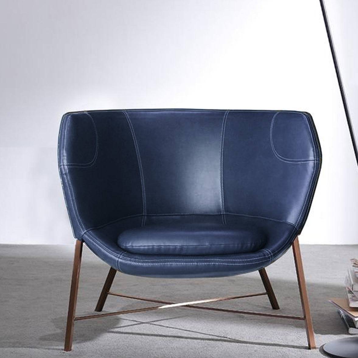 Blue Aprilia armchair from BEACON featuring plush fabric and modern design, perfect for living rooms or cozy spaces.