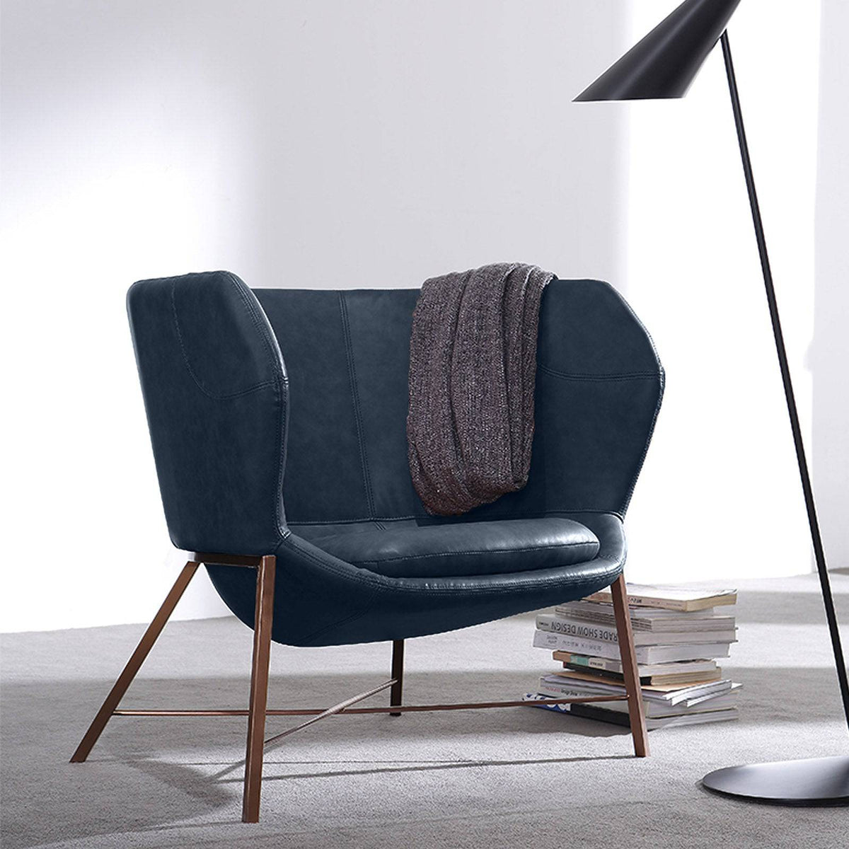 Aprilia armchair by Beacon with plush blue upholstery, modern design, and cushioned seat for comfortable seating.