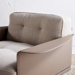A beige Avenor armchair display model from Beacon, with plush upholstery and modern design, shown from a side angle.