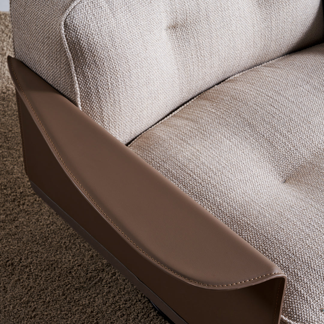 Avenor armchair display model by BEACON with plush fabric upholstery and modern design, shown from a side angle.