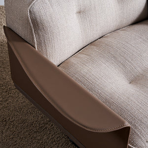 Avenor armchair display model by BEACON with plush fabric upholstery and modern design, shown from a side angle.