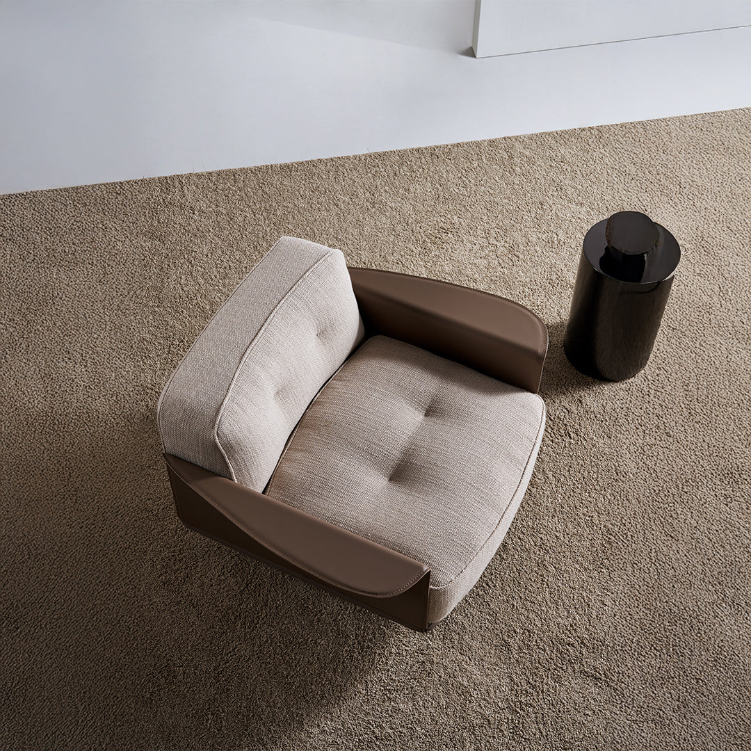 A beige BEACON Avenor armchair display model with plush upholstery and wooden legs, showcasing modern design.