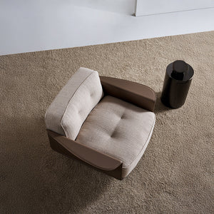 A beige BEACON Avenor armchair display model with plush upholstery and wooden legs, showcasing modern design.