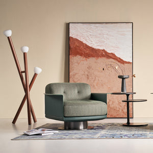 Green Avenor armchair from BEACON with plush fabric and modern design, ideal for living room or lounge area.