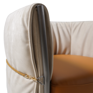 Beige Baxter armchair by BEACON with plush fabric, modern design, and cushioned seat for comfortable seating.