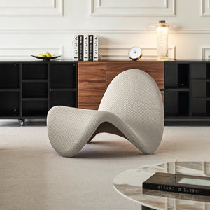 Beige Worm Lounge Chair by BEACON, modern lounge chair with curved design and beige upholstery, comfortable seating for living rooms.
