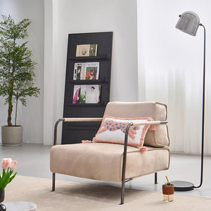 Beige Caesar lounge chair with black iron rack, modern design, and sturdy frame, perfect for stylish seating in living spaces.