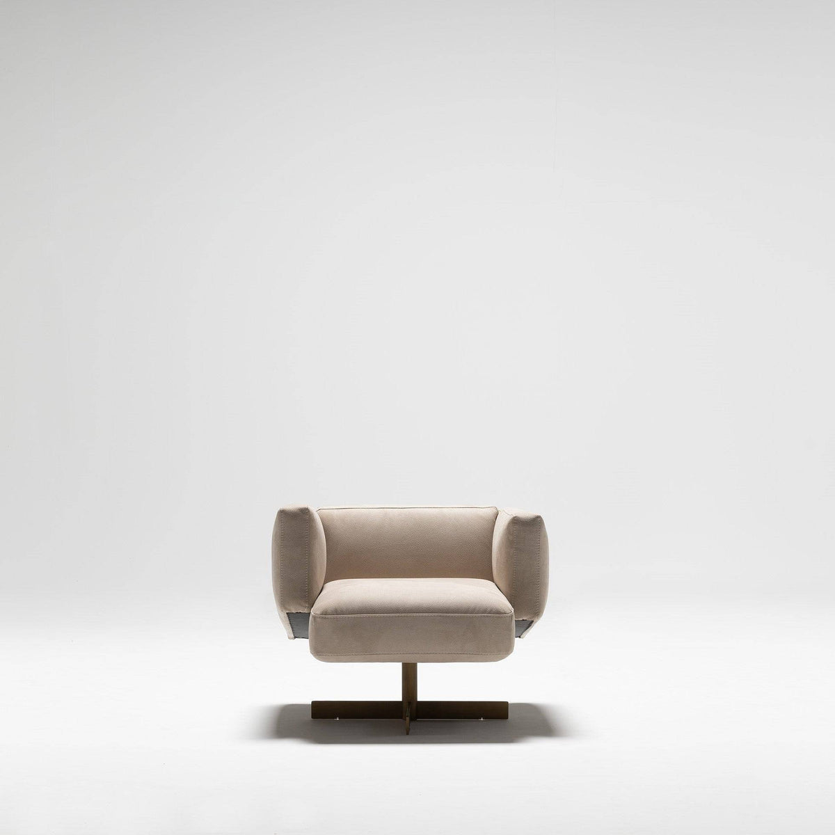 Beige HOMAGE KOLTUK Era Armchair with plush upholstery and modern design, shown from a side angle.