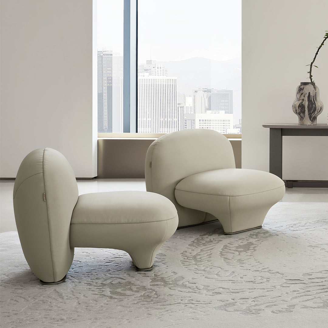 Euphoria Armchair by BEACON, plush fabric upholstery with cushioned seat and armrests, modern design in a neutral color.