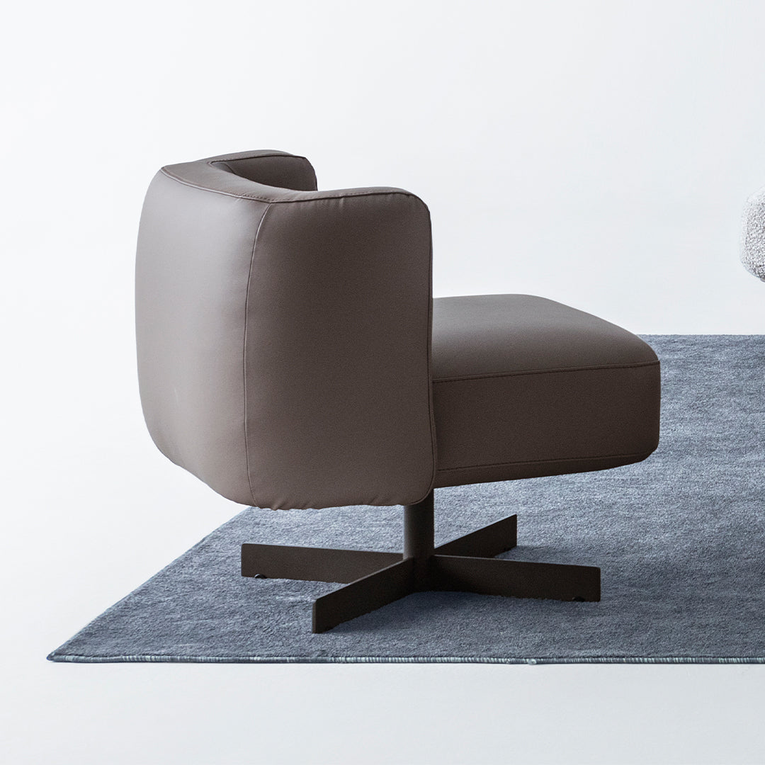 Foresta armchair by HOMAGE KOLTUK featuring a modern design with soft fabric upholstery and wooden legs.