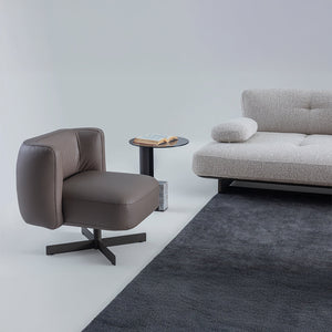 Foresta armchair by HOMAGE KOLTUK, featuring a modern design with plush fabric and wooden legs, perfect for living room seating.