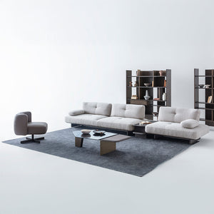 Foresta armchair by HOMAGE KOLTUK featuring a modern design with plush upholstery and wooden legs.