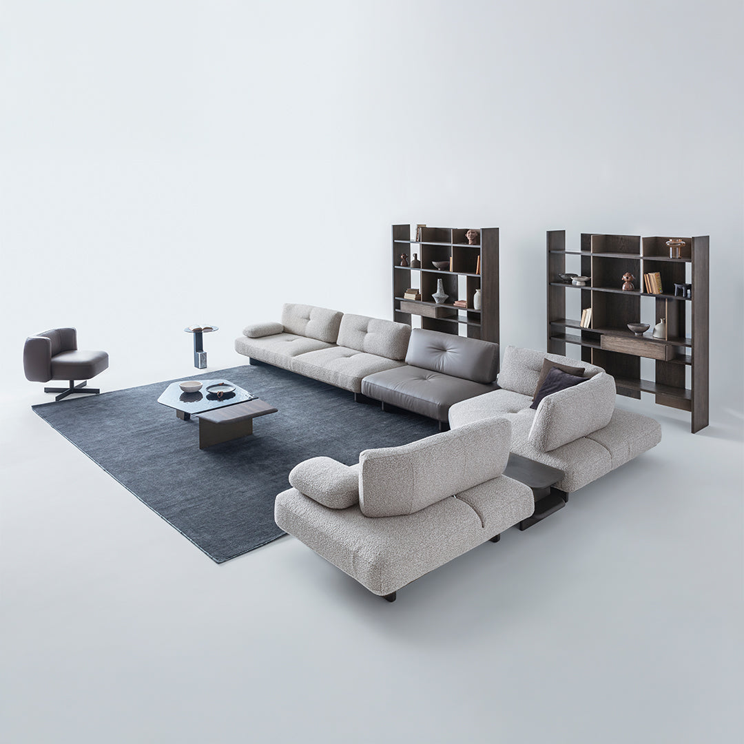 Foresta armchair by HOMAGE KOLTUK featuring a modern design with plush upholstery and wooden legs.