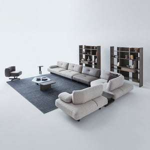 Foresta armchair by HOMAGE KOLTUK featuring a modern design with plush upholstery and wooden legs.