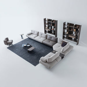 Foresta armchair by HOMAGE KOLTUK featuring a modern design with plush upholstery and wooden legs.