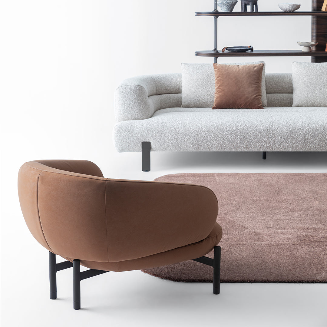 HOMAGE KOLTUK Freda armchair with plush fabric upholstery and modern design, shown in a cozy living room setting.