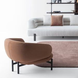 HOMAGE KOLTUK Freda armchair with plush fabric upholstery and modern design, shown in a cozy living room setting.