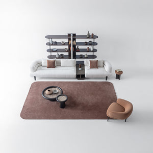 Freda armchair by HOMAGE KOLTUK with plush fabric upholstery and modern design, shown in a cozy living room setting.