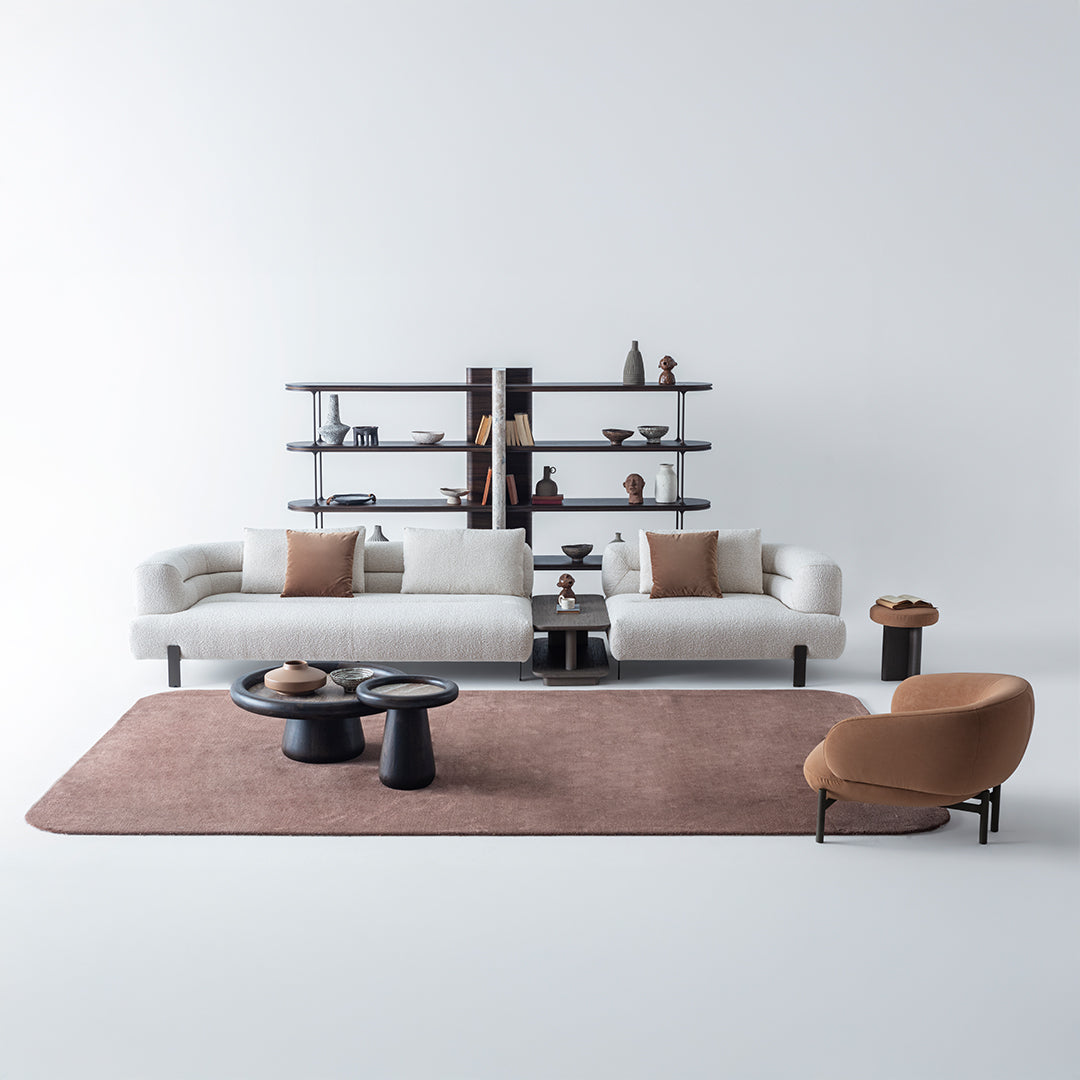 Freda armchair by HOMAGE KOLTUK featuring a modern design with plush upholstery and wooden legs.