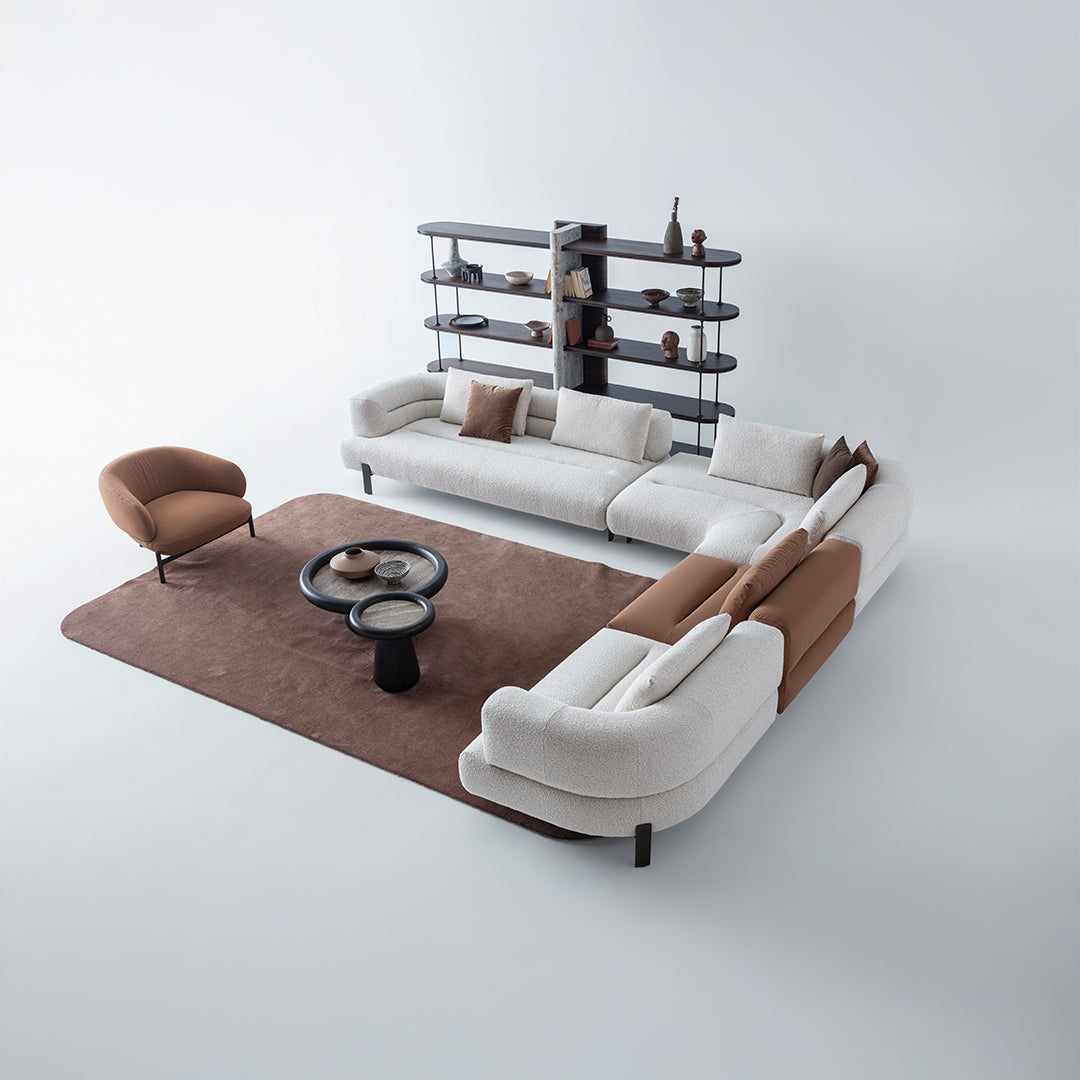 Freda armchair by HOMAGE KOLTUK featuring a modern design with plush upholstery and wooden legs.