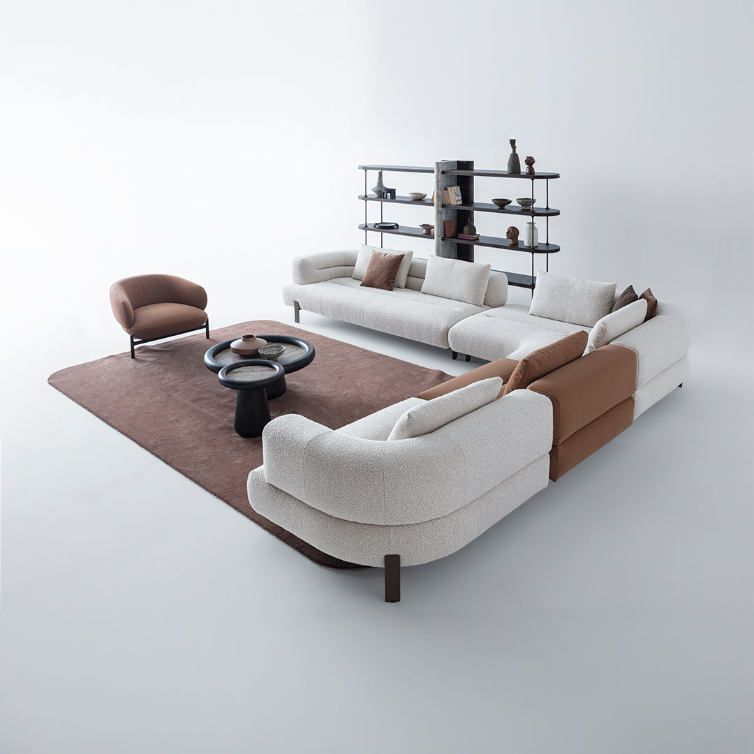 Freda armchair by HOMAGE KOLTUK featuring plush upholstery and modern design, shown in a cozy living room setting.
