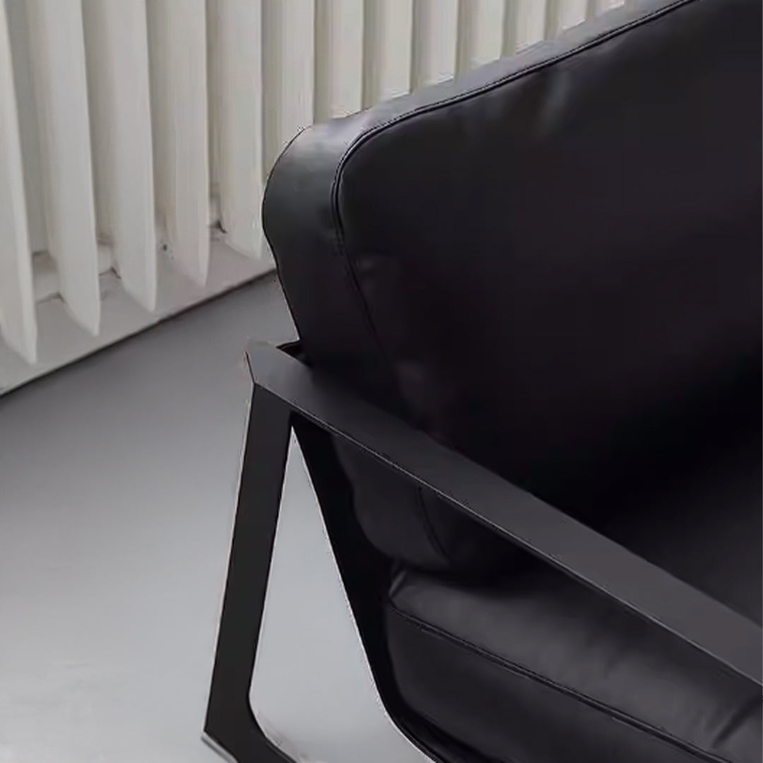 Black Lille Lounge Chair LC008 by BEACON featuring a modern, cushioned design with sleek black upholstery and wooden legs.